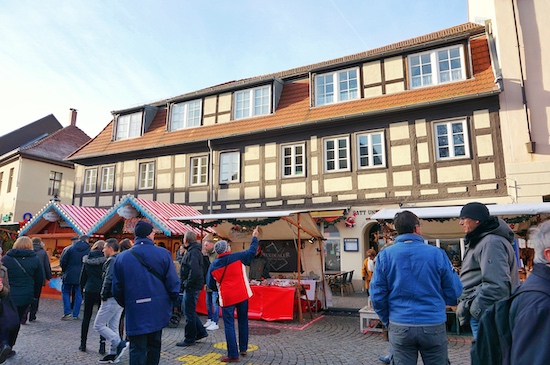 people wandering the streets of old town spandau with food stalls in the background