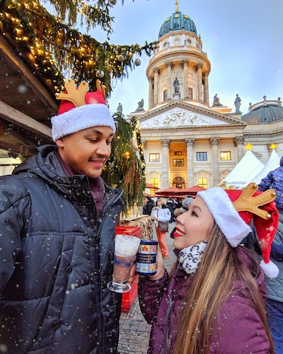 a couple posing in front of the französischer dom at gendarmenmarkt