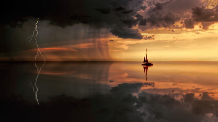 a yacht on the ocean sailing into a thunderstorm