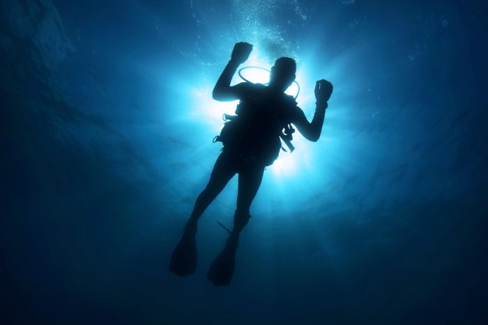 a beginners scuba diver floating in the ocean 