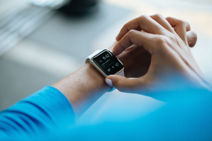 a woman looking at her apple iwatch