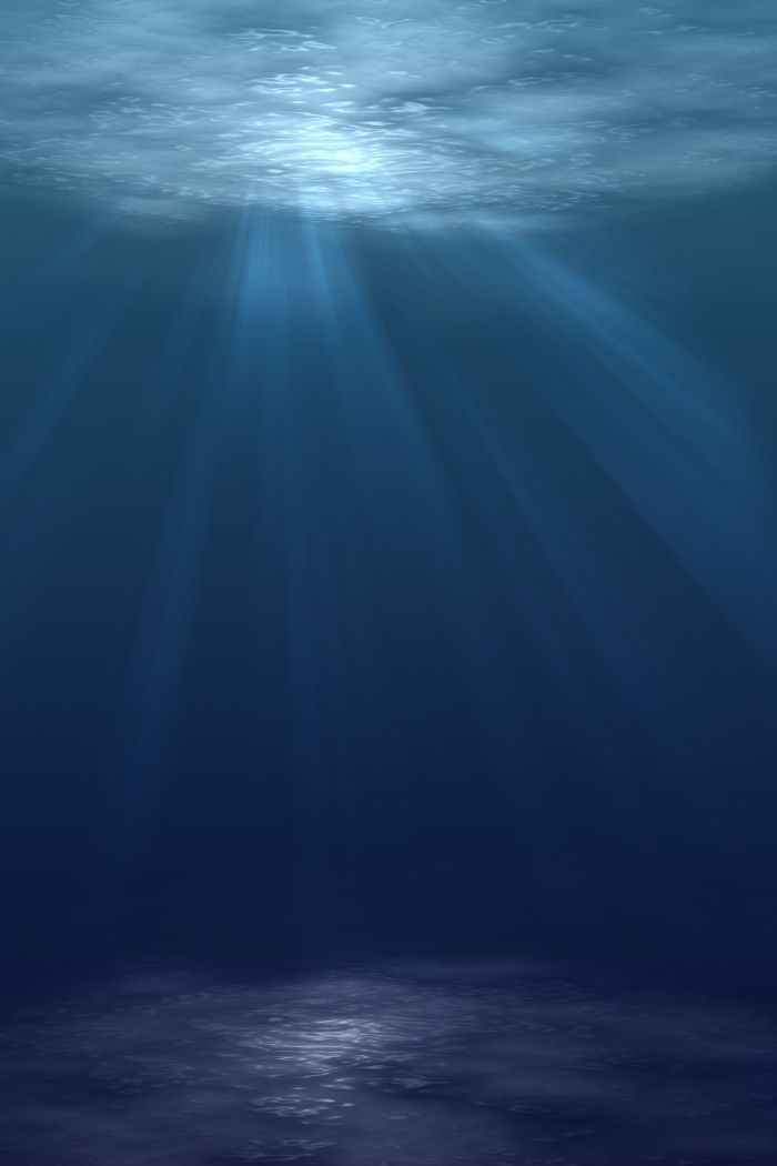 the sun shining light through the surface of the ocean