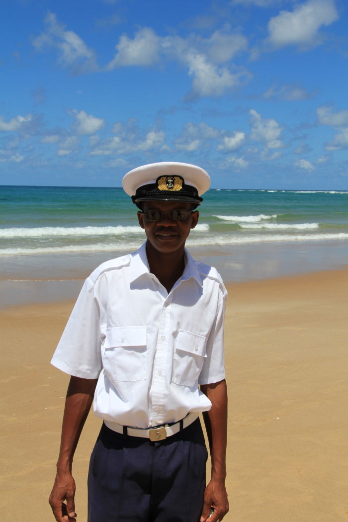 Mozambican traffic police officer posing for the camera along a beach in Mozambique 