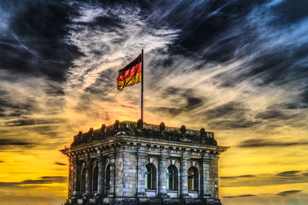 the German flag flying over a building in Berlin