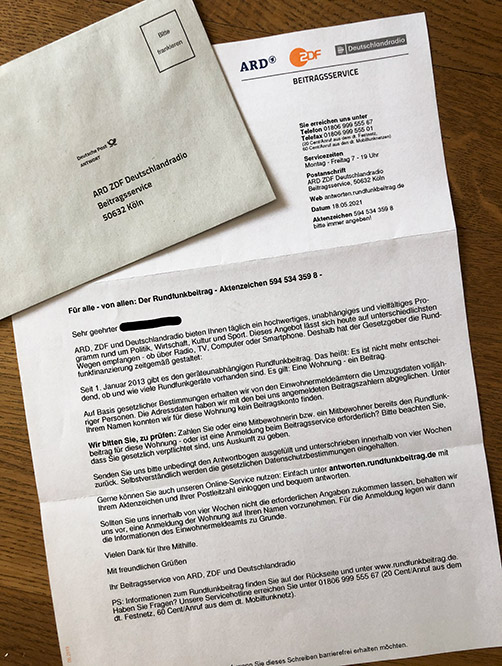 a rundfunkbeitrag letter with an envelope for paying tv tax in germany 