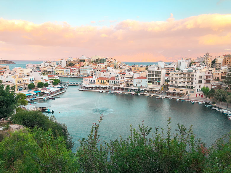 famous viewpoint in agios nikolaos with a view of the old town and the historic foundation at sunset