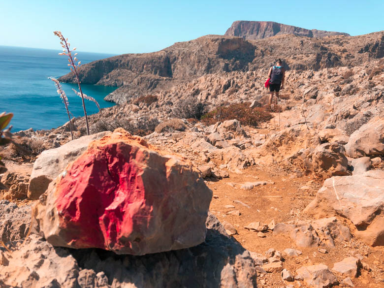 a rock painted with a big red dot marks the hiking trail to get to agiofaraggo beach in south crete
