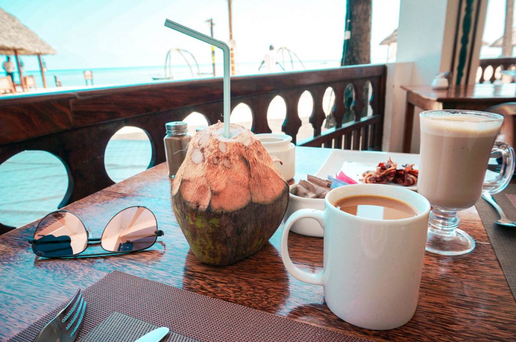 breakfast at a popular zanzibar hotel with a fresh coconut and coffee