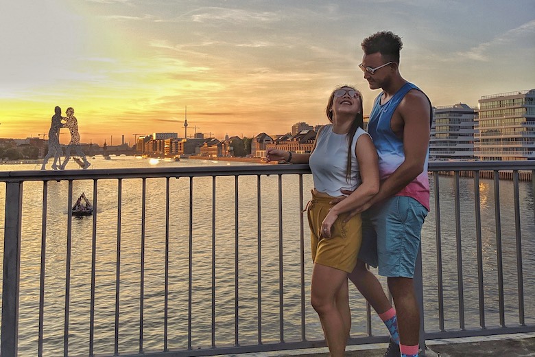 couple posing in berlin happy to get their anmeldung in germany