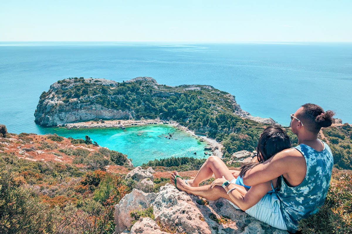 a couple looking down from a viewpoint over anthony quinn bay