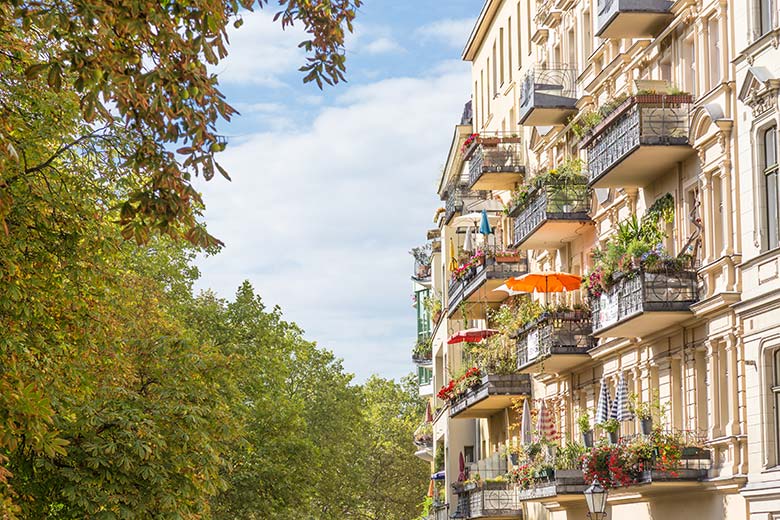 old building style apartments in berlin or altbau with trees on the other side