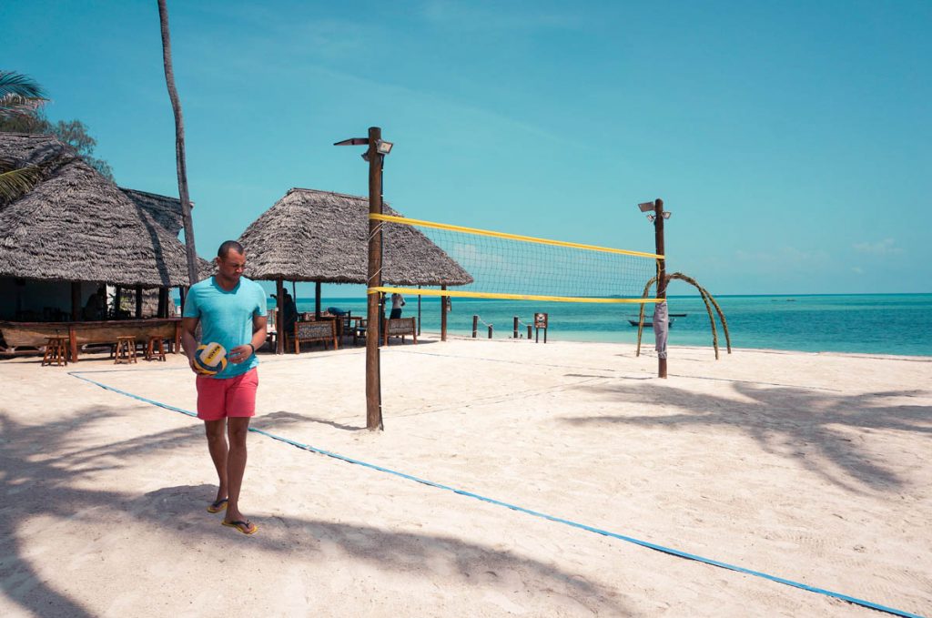 a man holding playing beach volleyball in nungwi zanzibar tanzania