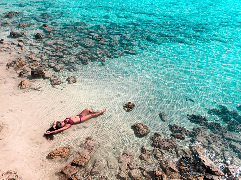 beautiful photography of a woman lying on a beach on a beach in kreta greece