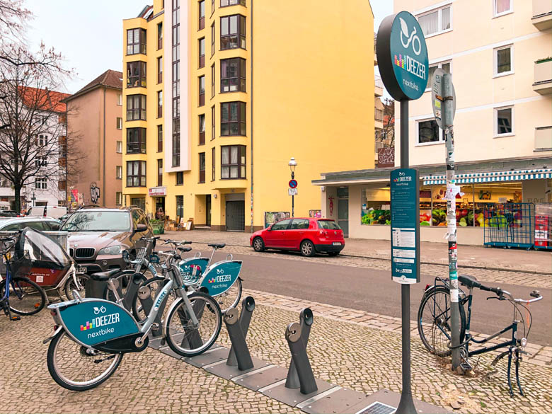 blue nextbike bicycle parked at a docking station in berlin germany