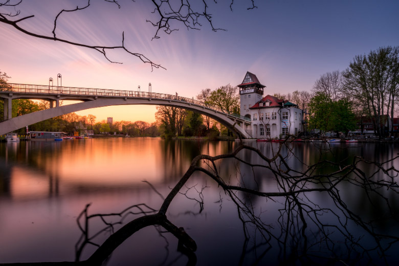 berlin sunset in summer overlooking bridge, lake and forest