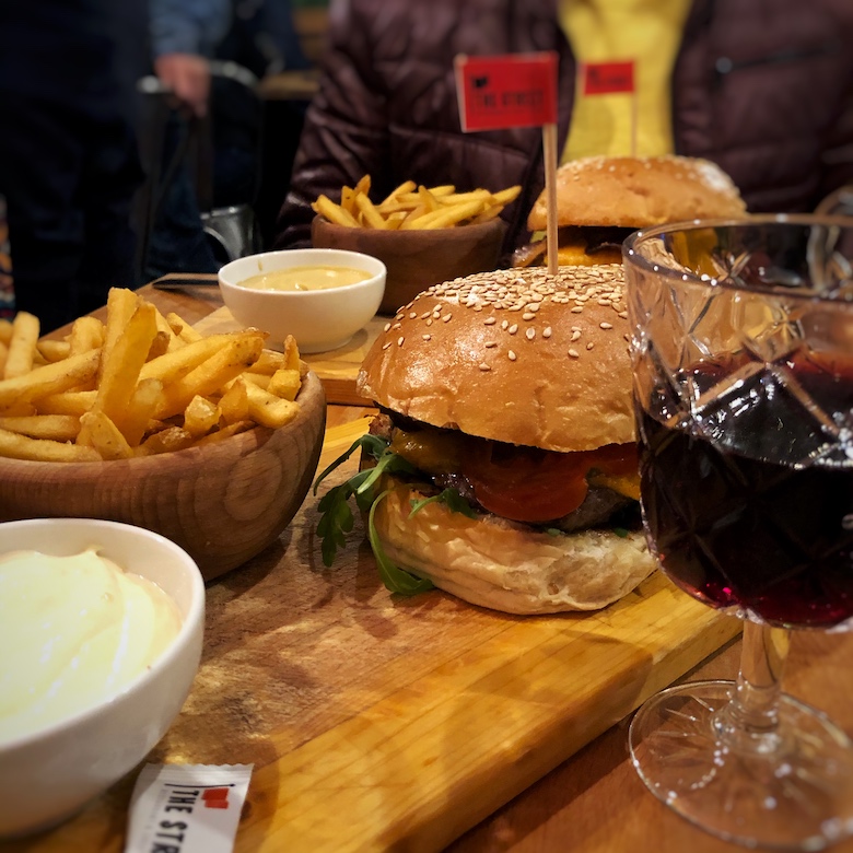 best burgers in prague with chips, sauce and an alcoholic drink