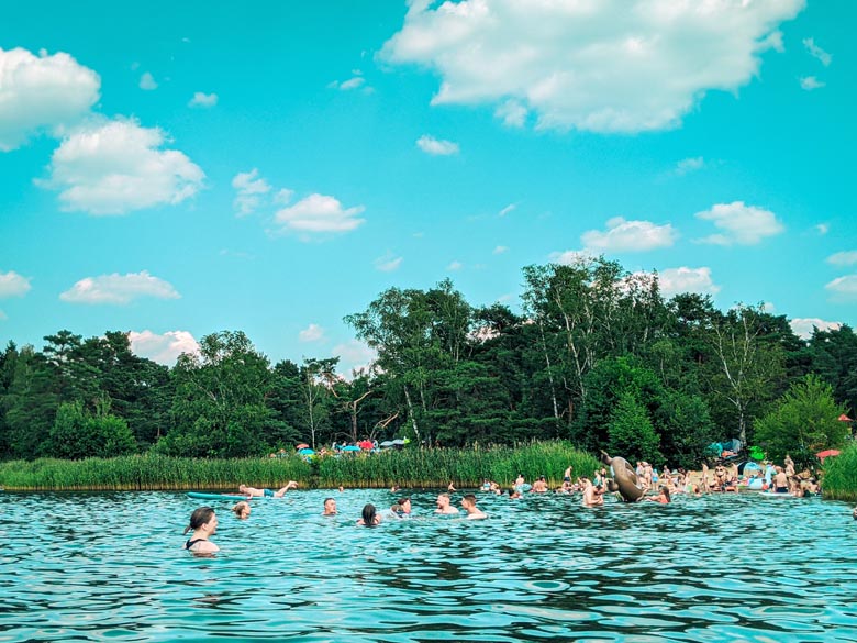 locals swimming in front of the free beach at Tonsee lake near berlin called Badesee Tonsee