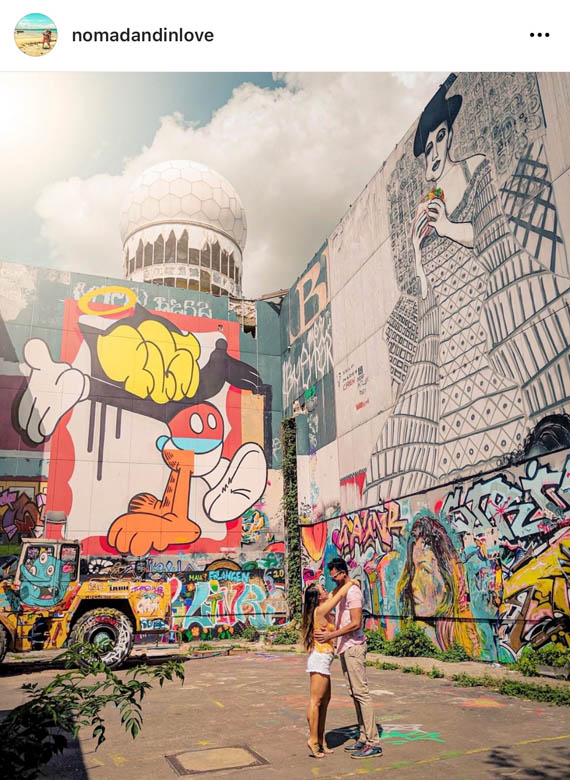 street photography of a couple at teufelbergs spy tower surrounded by colorful graffiti and street art