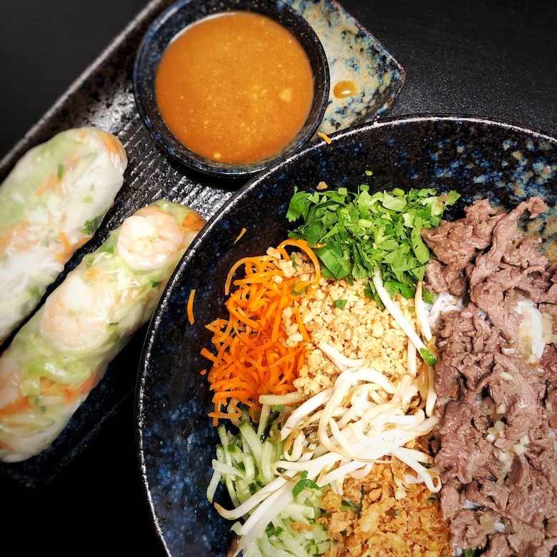 vietnamese noodle salad bowl with prawn summer rolls