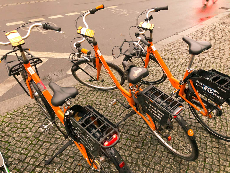 three orange city bicycles from donkey republic bike sharing in berlin germany 