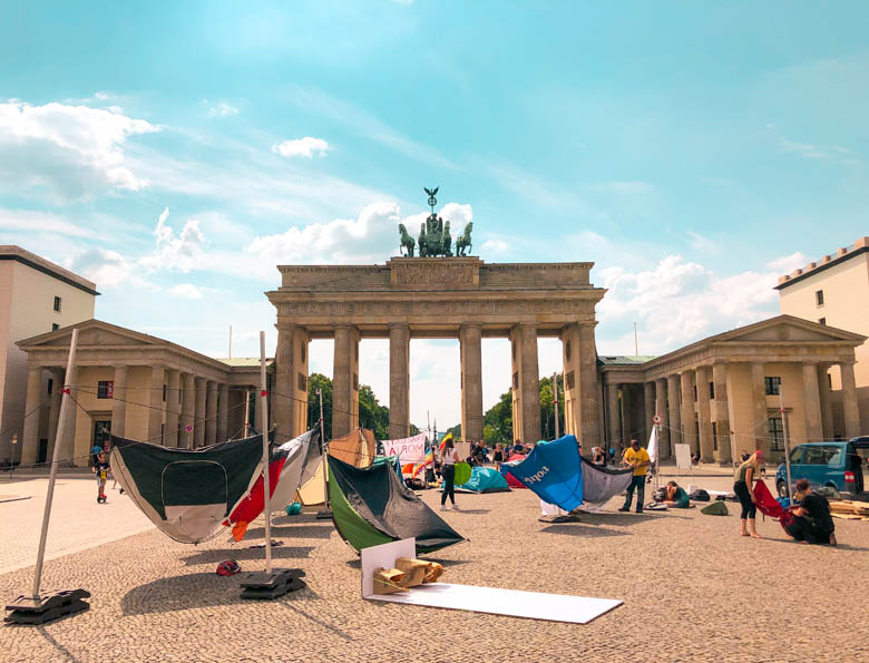 iconic Brandenburg tor in berlin whilst travelling during covid is empty as a protest is held here