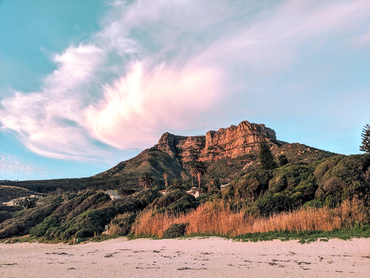 a view of table mountain from llandudno beach at sunset 