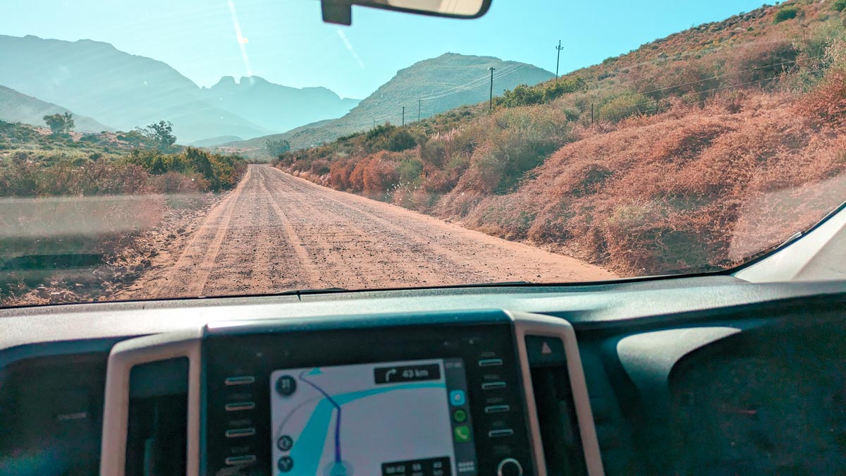 driving on a gravel road near cape town with a view from the inside of the car