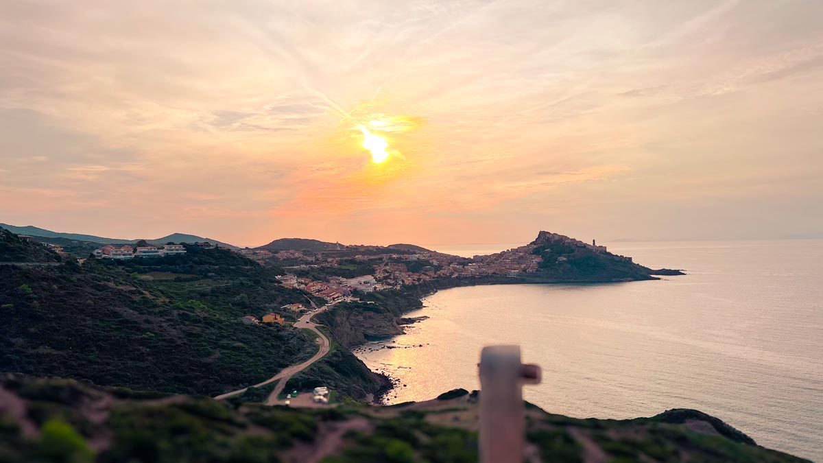 a orange sunset setting over the town castelsardo in north central sardinia