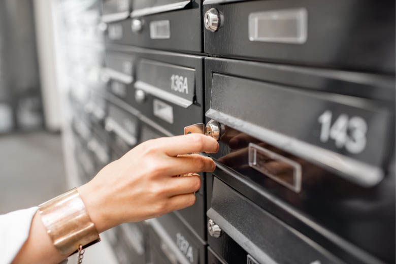 a woman opening her post box to check her mail when moving to germany