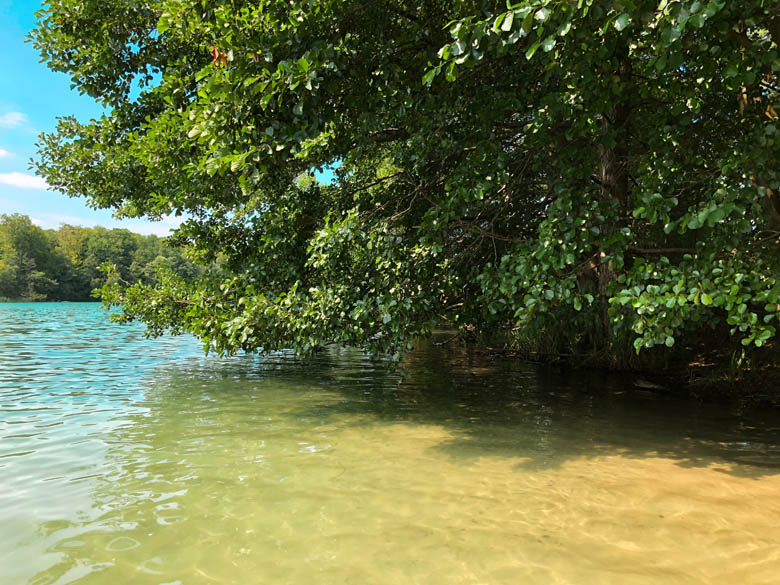 shallow waters of liepnitzsee lake in berlin with soft, white sand and crystal clear, turquoise coloured water