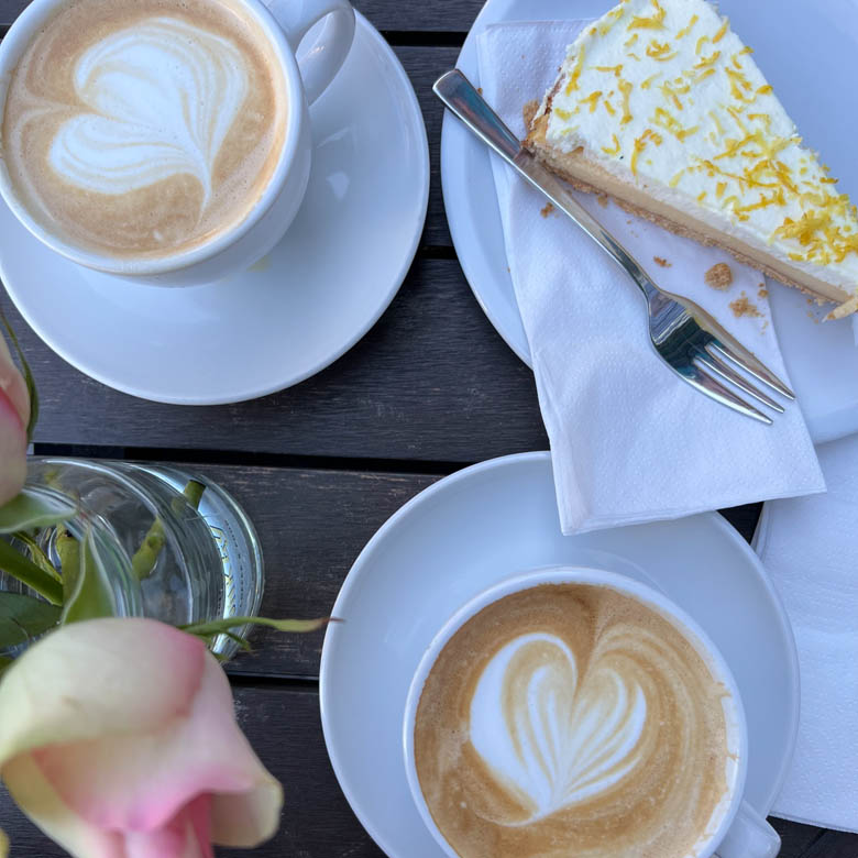 two coffees and a lemon cake at a coffee shop in germany