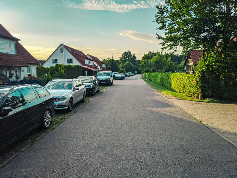 residential suburb with two storey houses and cars parked on the side of the road in berlin brandenburg germany
