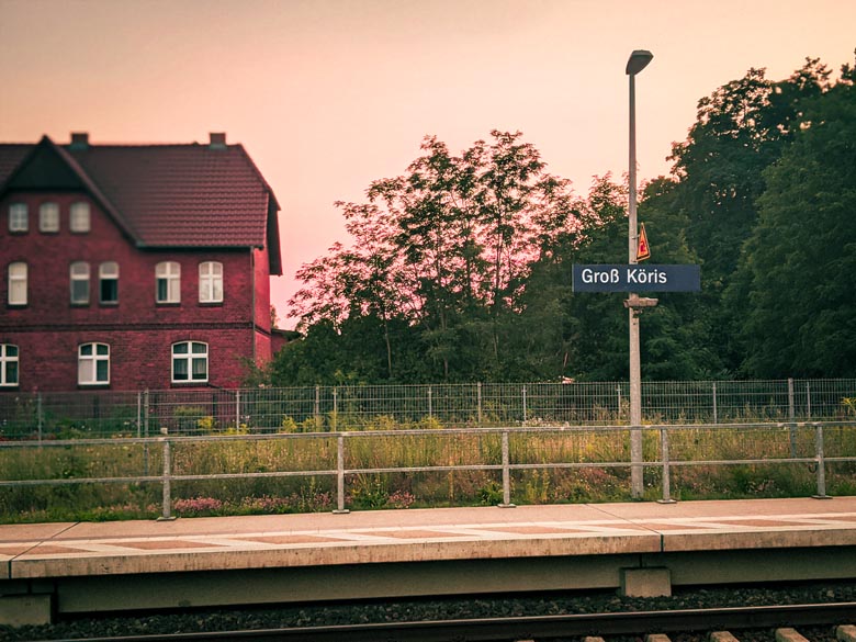 orange sunset lighting as passengers wait to take the train back to Berlin from Groß Köris train station in Germany