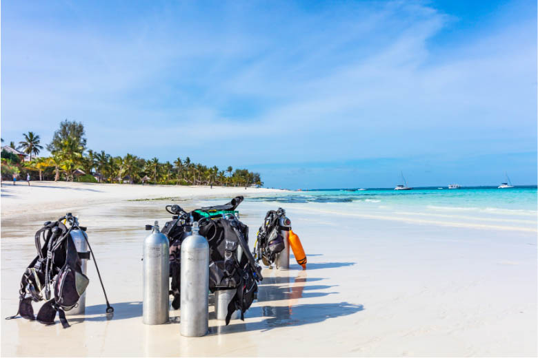 scuba diving gear standing in the sand on the beaches of zanzibar island