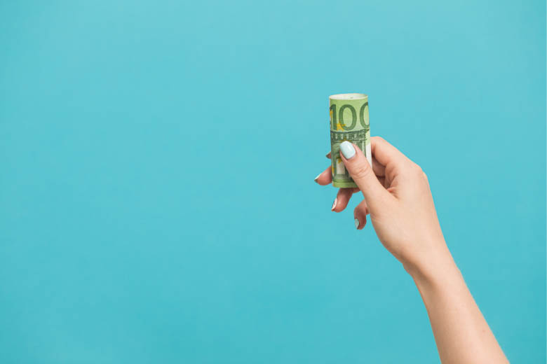 a woman holding a 100 EUR note in your hand against a blue background