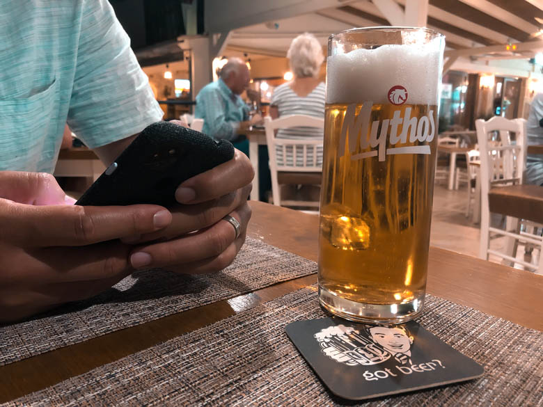 a glass of greek beer mythos on a table at a restaurant