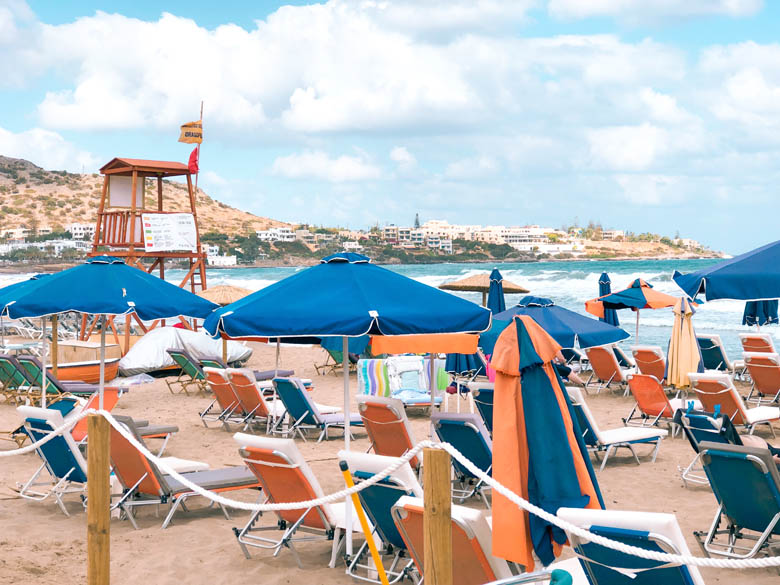stalis beach with sunbeds, umbrellas and lifeguards on duty