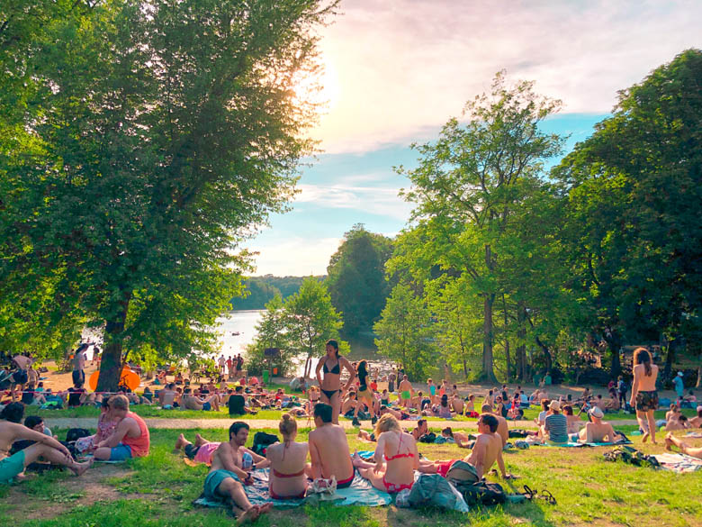 schlachtensee lake is the most popular in berlin and one of the best outdoor things to do with many people sitting on the grass during summer