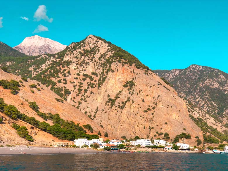 the beautiful coastal town of agia roumeli in south crete with mountains in the background