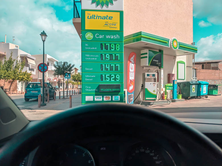 a green bp gas station in crete with gas prices on display