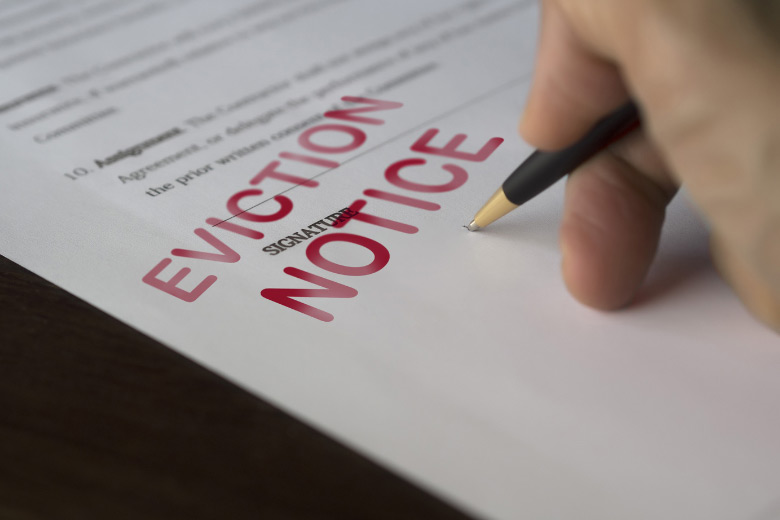 a person signing an eviction notice letter