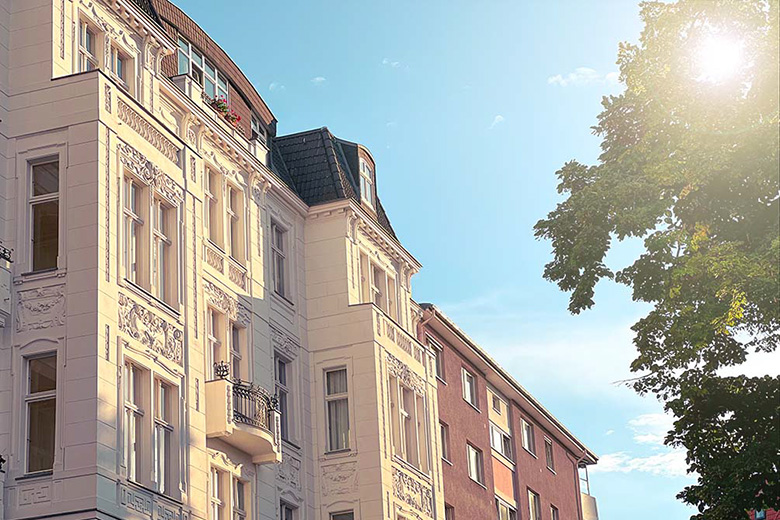 old style german apartment buildings in berlin germany against a blue sky