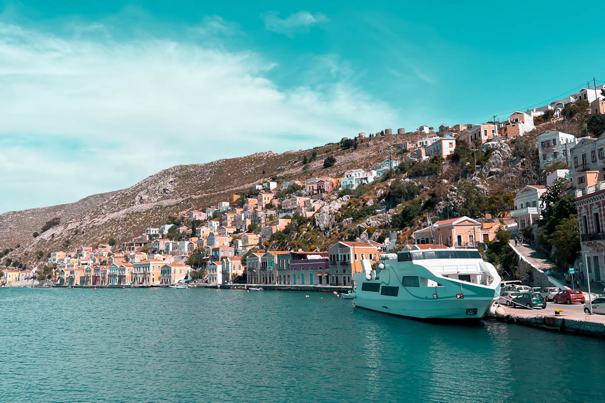 a ferry taking travelers and tourists from rhodes to symi island docked at the harbor