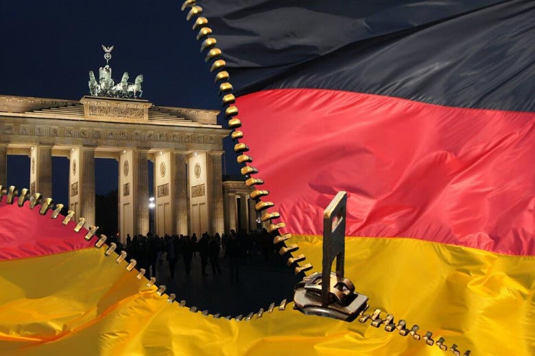 german flag in front of brandenburg gate in berlin