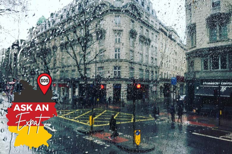 a rainy winter day in berlin germany with raindrops on a window pane looking out at the city center