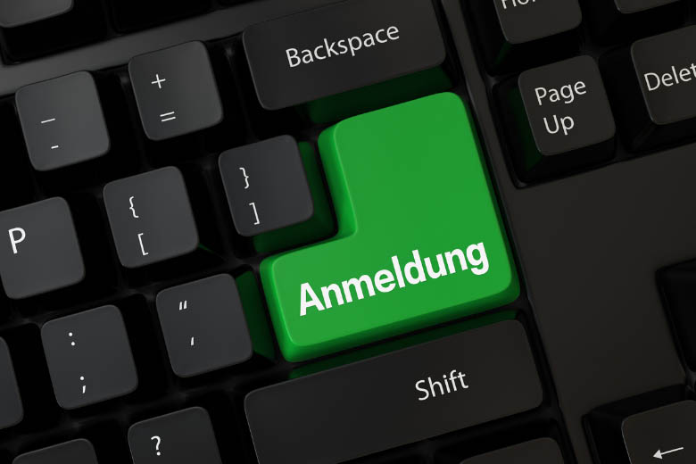 a black keyboard with large green anmeldung button and how to register your new address in Germany