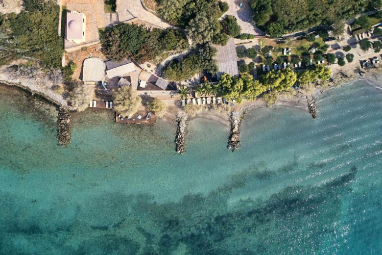 a droneshot of a beachfront hotel in crete greece and how expensive it is to book
