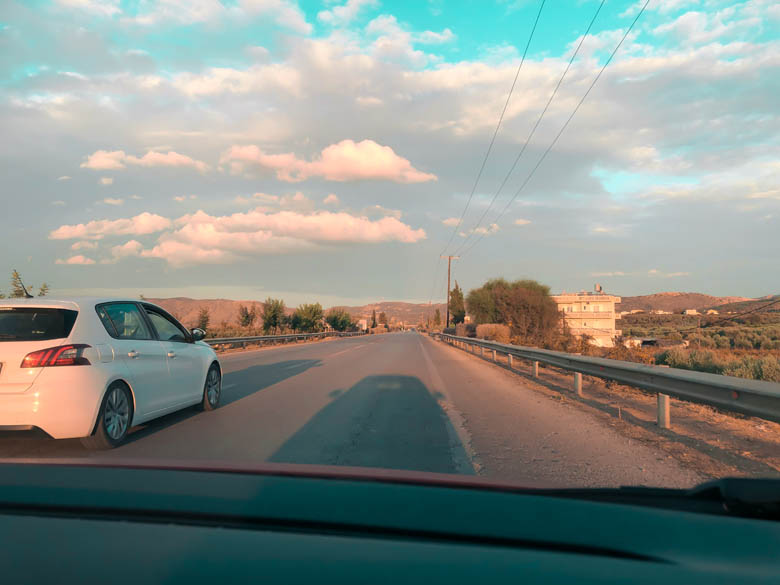 a car driving in the emergency lane in crete to allow another car to overtake