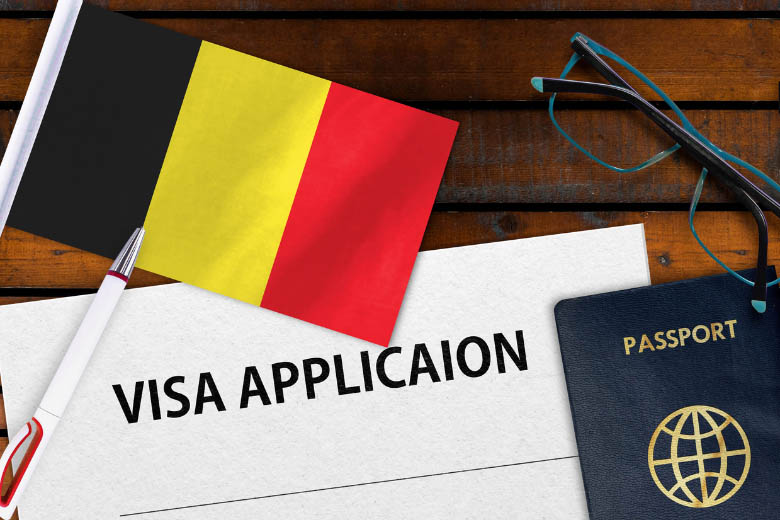 a german flag, visa application and passport lying on a wooden table 