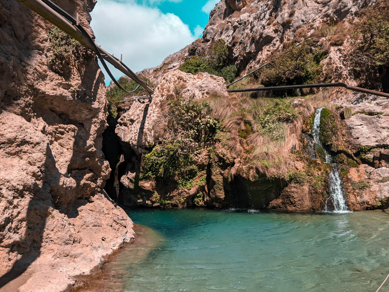turquoise blue waters that lead into the entrance to the waterfall at kourtaliotiko schlucht in kreta